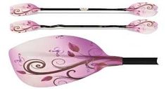 three pink paddles with floral designs on the sides and black handles, along with an oar