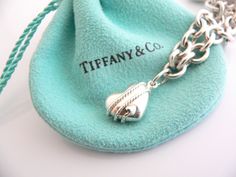 Overview:Offered for sale is a wonderful and gorgeous Tiffany & Co. Sterling Silver 3 Heart Arrow Charm Dangle bracelet. Definitely a Tiffany piece that you will get your money's value for. It works perfectly with pretty much any attire your put on, AND is an awesome statement piece. Very pretty and unique piece - the piece has 3 gorgeous Heart / Arrow charms dangling on it! It is the perfect bracelet that fits a lifestyle on the go -- the piece can be worn to pretty much any occasion! It is Turquoise Heart Charm Bracelet Gift, Tiffany Blue Heart Bracelet, Silver Heart-shaped Sterling Silver Charm Bracelet, Heart-shaped Turquoise Necklace With Heart Charm As Gift, Nickel-free Heart-shaped Metal Charm Bracelet, Unique Pies, Dangle Bracelet, 3 Hearts, Bracelet Bangle