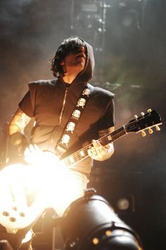 a man playing an electric guitar on stage