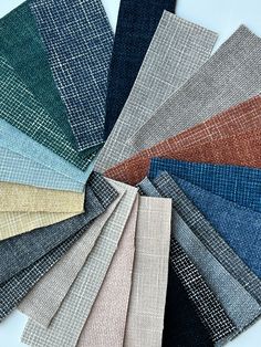 many different colors of fabric laid out on top of each other