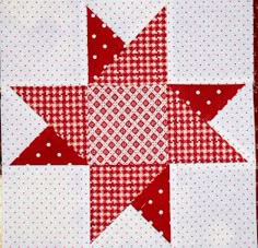 a red and white quilted star is shown