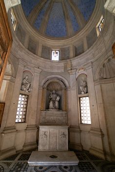 the inside of a building with statues and windows