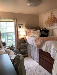 a bedroom with a bed, desk and window in it's corner area that has white carpet on the floor