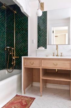 a bath room with a sink a mirror and a bath tub