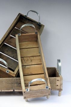 an open wooden box with metal handles