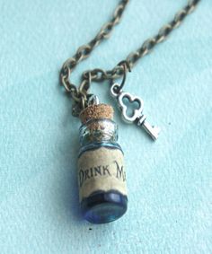 "this necklace features Alice in wonderland inspired drink me potion. the glass vial/bottle pendant measures 2 cm tall, and is securely attached to a bronze chain necklace that measures 24\" in length. a Tibetan silver key charm completes this piece." Witch Potion Necklace, Drink Me Potion, Potion Necklace, Coffee Necklace, Bronze Chain Necklace, Alice In Wonderland Costume, Wonderland Costumes, Bottle Pendant, Alice In Wonderland Tea Party