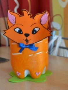 an orange cup sitting on top of a wooden table