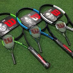 four tennis rackets laying on the ground with an image of two men's faces