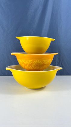 three yellow bowls stacked on top of each other