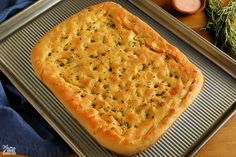 a square pizza sitting on top of a metal pan