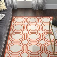 an orange and white rug in a living room