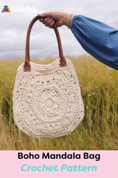 a hand holding a crocheted bag in front of tall grass with the text boho mandala pres 40k