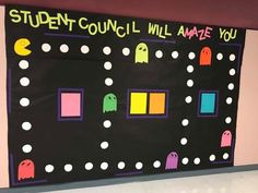 a bulletin board with pacman and ghost faces on it that says student council will amae you