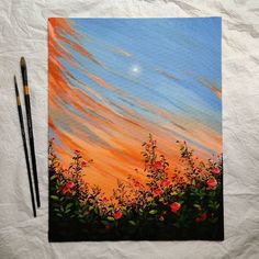 a painting with two pencils next to it