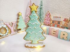 a christmas tree made out of cookies next to other cookie decorating items on a table