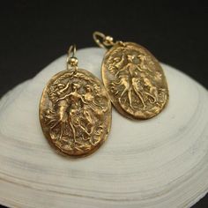 Those Three Graces cameo earrings are handmade and reproduced from an antique victorian cameo.Handmade bronze 18th c. Victorian cameo reproduction depicting the three Graces, daughters of Aphrodite, Goddess of Love and Beauty.The Three Graces also known as the Charites were the Goddesses of charm, beauty, nature, human creativity, and fertility. They ordinarily numbered three, from youngest to oldest: Aglaea ("Splendor"), Euphrosyne ("Mirth"), and Thalia ("Good Cheer"). • The cameos are 7/8" x 1 Antique Earrings With Historical Design, Victorian Wedding Earrings With Antique Finish, Antique Drop Earrings With Antique Finish, Antique Style Drop Earrings With Antique Finish, Antique Finish Bronze Wedding Earrings, Victorian Drop Earrings With Antique Finish, Victorian Antique Finish Drop Earrings, Historical Bronze Brass Jewelry, Bronze Brass Jewelry With Historical Design