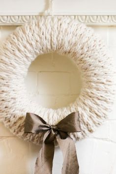 a white knitted wreath hanging on the wall