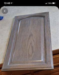 a close up of a kitchen cabinet door with wood grain on the bottom and sides