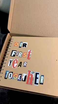 an open cardboard box with stickers on it and the words our first year together