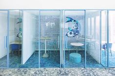 a room with glass walls and blue flooring