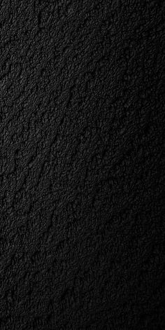 a black textured wall is shown in this image