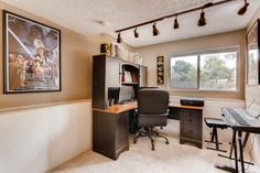 a home office with a desk and computer