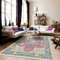 a living room filled with furniture and a large rug