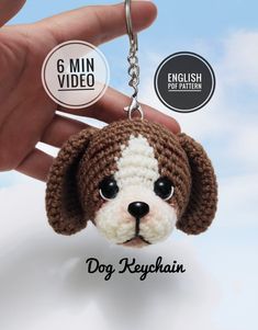 a small dog keychain is being held by someone's hand with the tag on it