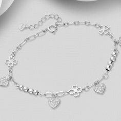 Elevate your elegance with our 925 Sterling Silver Clover Bracelet, featuring a heart design and sparkling CZ diamonds. Adjustable for perfect fit. Bracelet Length: 6½ - 7½" Elegant Silver Diamond Heart Bracelet, Fine Jewelry White Gold Heart Bracelet With Cubic Zirconia, Valentine's Day White Gold Cubic Zirconia Diamond Bracelet, Silver Diamond Heart Bracelet As Gift, Silver Cubic Zirconia Heart Bracelet For Wedding, Elegant Silver Heart Bracelet With Cubic Zirconia, Elegant White Gold Charm Bracelet For Valentine's Day, Elegant Silver Diamond Bracelet For Valentine's Day, Valentine's Day Heart Bracelet In Cubic Zirconia