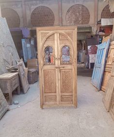 an old wooden door is in the middle of a room filled with other wood furniture