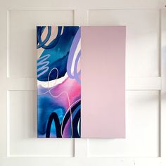 an abstract painting hangs on the wall