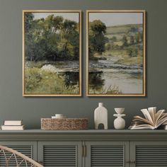 two paintings on the wall next to a chair and bookshelf with an open book