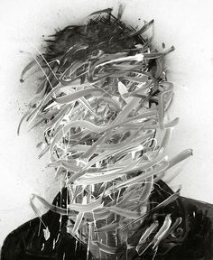 a black and white photo of a man's head covered in shredded up papers