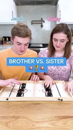 two young people are playing together on the kitchen counter with an advertisement above them that says brother vs sister