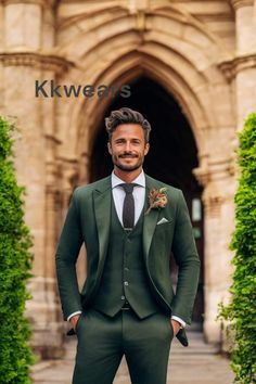 a man wearing a suit and tie standing in front of a building with an archway