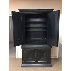 a black cabinet with doors open in a room