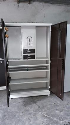 the inside of a storage cabinet with doors open