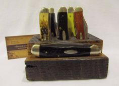 an assortment of knives sitting on top of a wooden block