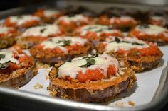 baked stuffed mushrooms with sauce and cheese on a baking sheet, ready to be eaten