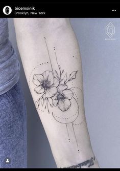 a woman's arm with flowers and lines on the back of her left arm