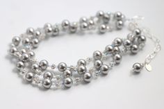 Our Silver Elegance necklace is a stunning accessory that pays tribute to classic elegance with its graceful, cascading strands of pearls, rhinestones and crystals. Featuring gorgeous Swarovski© glass pearls in different hues, a sparkling rhinestone ball and Swarovski© Crystals. Silver chain is adjustable ready to fit any outfit. Make it your own, and wear it in any way that suits you. Silver Strand, Murano Glass Beads, Swarovski Pearls, Classic Elegance, Artisan Jewelry, Semiprecious Stones, Precious Stones, Freshwater Pearls, Silver Chain