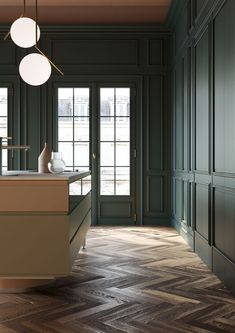 an empty kitchen with green walls and wooden flooring, along with large windows that look out onto the street