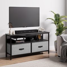 a flat screen tv sitting on top of a black stand