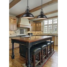 a kitchen with an island and bar stools