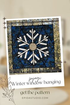 a blue and white quilt with the words winter window hanging