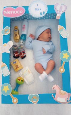 a baby laying in a blue box surrounded by toys