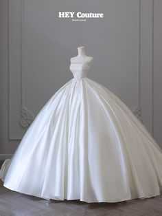 a white wedding dress on display with the words hey couture written above it