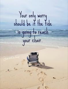 a bench sitting on top of a sandy beach next to the ocean with a quote