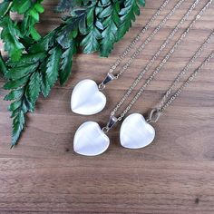 This necklace is made from a white cats eye stone which has been cut into an heart. The stone hangs from a silver plated chain. You can choose the length of the necklace you prefer. You will get a necklace at random. Please note that all necklaces are handmade and may differ from the pictured. The picture shows multiple necklaces. You will receive one necklace with one pendant. Ewelina Pas Jewelry White Heart-shaped Crystal Necklace For Gift, White Heart-shaped Crystal Necklace Gift, White Sterling Silver Crystal Necklace For Gift, White Heart-shaped Moonstone Jewelry, Sterling Silver White Crystal Necklace Gift, White Sterling Silver Crystal Necklace As Gift, White Heart Cut Necklace For Gift, Silver Heart Moonstone Necklace, Silver Heart-shaped Moonstone Necklace