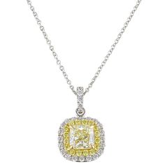 If you've always wanted to add yellow diamonds to your collection, then look no further. A square modified brilliant cut-cornered (radiant) 1.04 carat Natural Fancy Light Yellow Diamond with even color distribution is delicately set with four prongs in the center of this 18k white and yellow gold pendant. Smaller round yellow and colorless diamonds form a double tiered halo perimeter and cascade upwards towards the bail of this magnificent pendant which slides freely on an 18" long white gold ca Light Yellow Diamond, Fancy Light, Yellow Diamonds, Fancy Lights, Colorless Diamond, Yellow Gold Pendants, Diamond Pendant Necklace, Yellow Diamond, Light Yellow